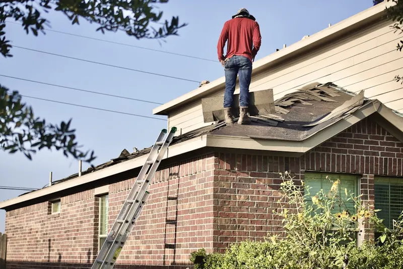 Professional roofer working on a residential roof in Laurel Oaks